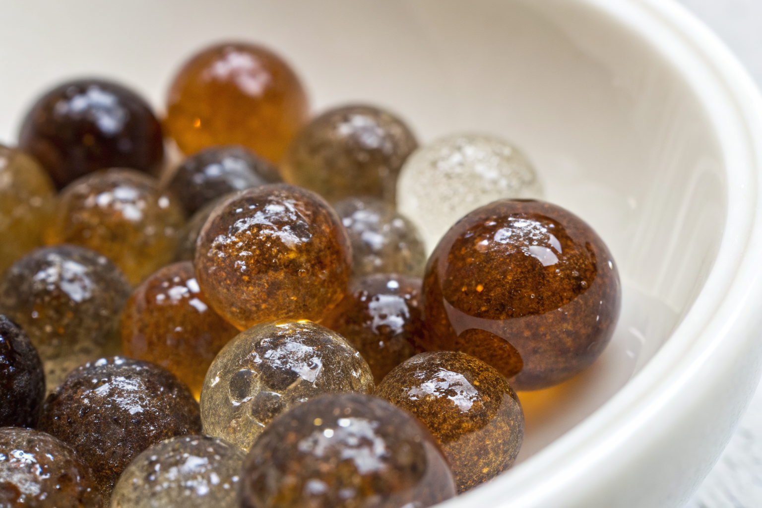 Macro shot of resin beads with metallic film from iron.